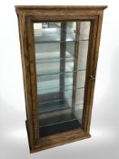 A reproduction oak display cabinet with glass inner shelves, 76 cm x 38 cm x 26 cm.