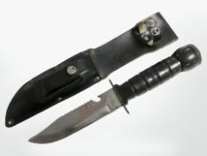 A survival knife in sheath with compass-inset pommel, length 29 cm.