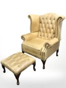A contemporary studded tan leather chesterfield wingback armchair and matching footstool,
