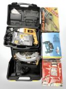 A group of boxed power tools, Black and Decker chain saw, bench grinder, automatic battery charger,