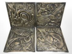 A set of four bronzed plaster relief panels depicting flora and fauna,