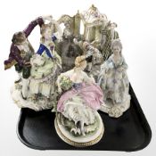 A Capodimonte porcelain figure of a seated lady holding a songbird and three further continental
