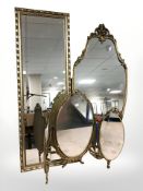 Two reproduction gilt framed mirrors and a further triptych mirror,