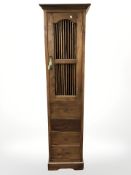 A sheesham wood slim cabinet with drawers beneath, 50 cm x 46 cm x 192 cm.
