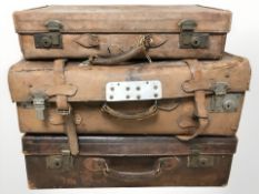 Three antique brown leather luggage cases,
