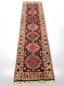 A Heriz runner, North-West Iran, 275 cm x 75 cm.