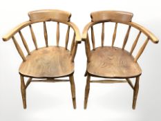 A pair of early 20th century elm spindleback armchairs.