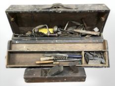 An antique joiners toolbox containing assorted carpentry tools, hand drills, hammers, chisels,