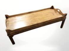 A reproduction mahogany low coffee table, length 123 cm.