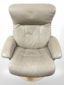 A contemporary swivel stitched leather armchair