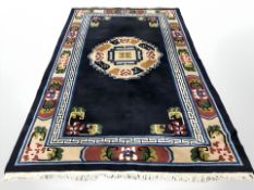 A Chinese carpet on indigo ground, 310 cm x 184 cm.