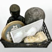 A ceramic figure of Buddha, a further bust and three relief plaques.