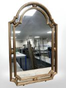 A reproduction gilt framed domed mirror, 110 cm x 67 cm.
