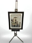 A wooden easel and a watercolour painting depicting a canal scene.