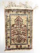 An Anatolian silk wall hanging/rug, 70 cm x 41 cm.