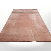 A large roll of peach-coloured carpet,