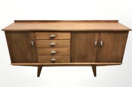 A 20th century teak sideboard, 183 cm x 46 cm x 87 cm.