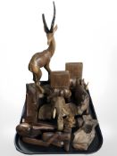 A group of African style wooden carvings including rhinoceros bookends,