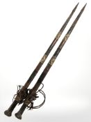 A pair of African leatherwork staffs, length 87 cm.