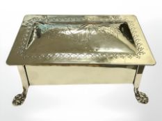 An Arts & Crafts polished brass table box with teak lining, on paw feet,
