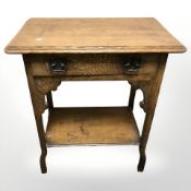 An Arts and Crafts single drawer side table, 61 cm x 37 cm x 74 cm.