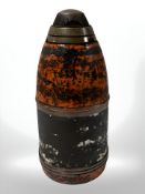 An artillery shell with brass fuse