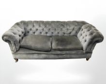 An early 20th century Chesterfield three seater settee in modern grey upholstery,