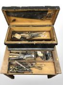 An antique tool box containing carpentry tools, chisels,