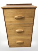 A teak three drawer chest, 64 cm x 44 cm x 111 cm.