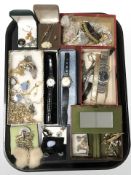 A tray of lady's and gent's wristwatches, costume necklaces, brooches, several pairs of earrings,