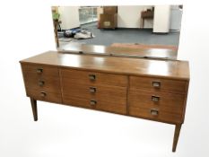 A 20th century teak mirrorback dressing table, 150 cm x 47 cm x 114 cm.