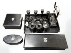 An extensive ebony dressing table set comprising of boxes, pots, manicure stand,
