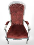 A silvered armchair in floral fabric, width 63 cm.