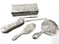 A Chinese export silver dressing table set, circa 1900, comprising hand mirror, two hair brushes,