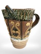 A treacle glazed earthenware pitcher, height 26 cm.
