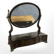 A reproduction mahogany serpentine front dressing table mirror, width 52 cm.