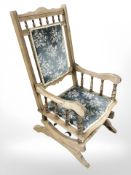 An early 20th century oak framed rocking chair.