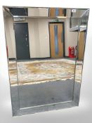 A contemporary frameless mirror 76 cm x 107 cm