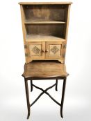 A late Victorian inlaid mahogany occasional table and an Arts and Crafts oak open bookcase,