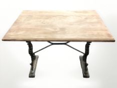 A rectangular garden table on cast iron support,