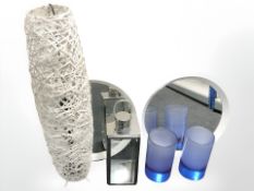 Two contemporary mirrors, a wicker floor lamp, a metal lantern and two vases.