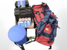 A group of camping stoves, butane cans, further camping equipment, rucksack, etc.