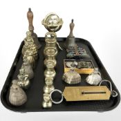 A group of graduated brass weights, figural hand bell, bowls, miniature globe,