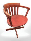 A Scandinavian painted beech swivel chair.