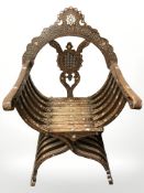 A 19th century Syrian carved hardwood, mother of pearl and bone inlaid Savonarola style armchair,