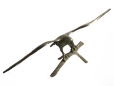 A brass figure of an eagle perched on branch, width 46 cm.