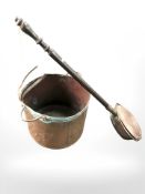 A 19th century copper twin handled pot and a further bed warming pan.