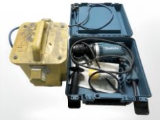 A 110 V transformer and a Makita hammer drill.