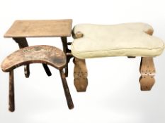 A camel stool with leather cushion and two further stools.