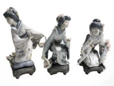 Three Lladro figures of Geisha arranging flowers, tallest 20.5 cm.